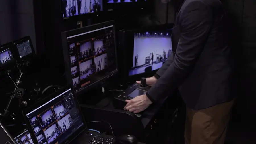 PTZ camera control position showing multiple remote camera feeds on a monitor wall.