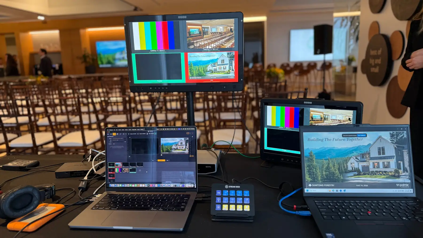 Multi-camera live production position at a corporate event, with a multiview monitor showing camera and slide sources.